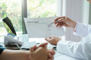 Doctor explains the health check to the patient with treatment guidelines at the doctor office.